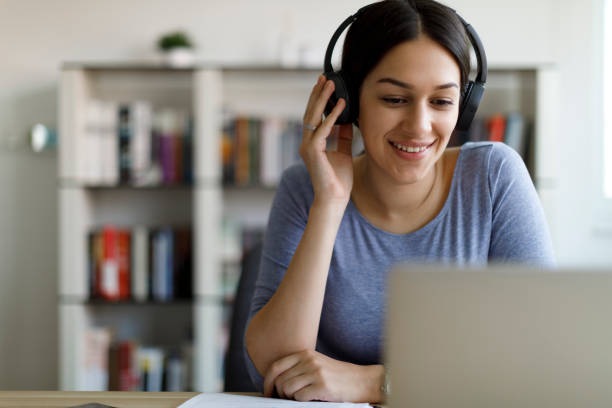 istock Young smiling woman having video call 1354627945
