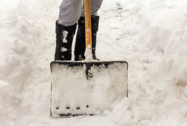 istock A man cleans the paths in the yard from snow. 1354629634