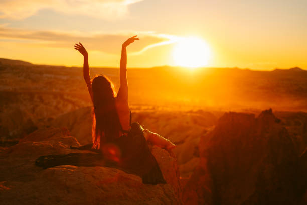 istock young woman dancing sitting down at sunset. 1354631158