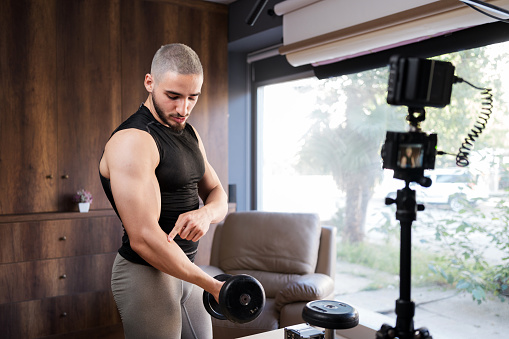 Muscular Athletic Young Male Instructor Streaming Online Bodybuilding Training Course