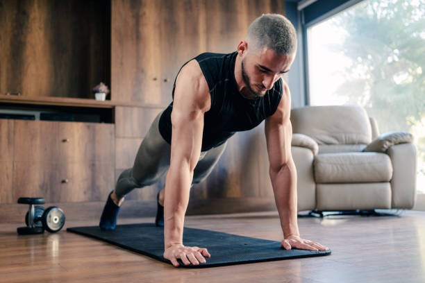 istock Muscular Athletic Young Man Training For Body Building At Home 1354641437