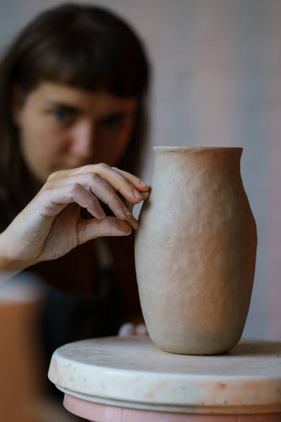 istock Handmade creation occupation: process of moulding and sculpturing pottery in creative art studio 1354642569