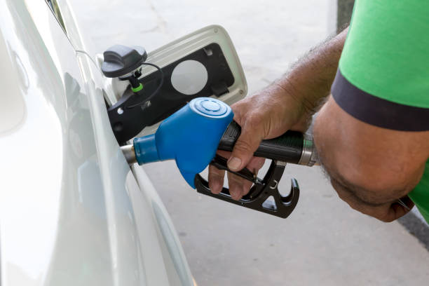 istock Man refueling gasoline fuel in white car 1354643986