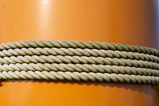 Rope tied to a orange pole.