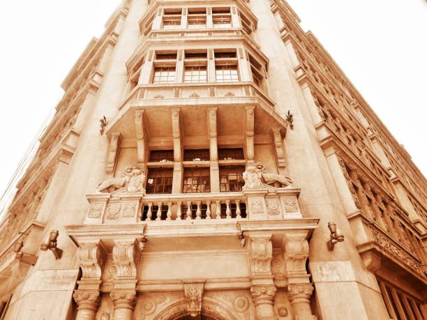 Ornate haussmannian building facade featuring a classic domed roof and attic windows