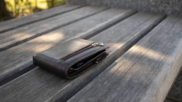 A leather money wallet left on a park bench. Lost thing. stock photo