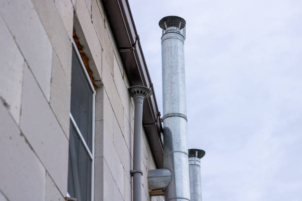 Ventilation pipes. Metal chimney in a brick house. Gas extractor hood in the house. stock photo