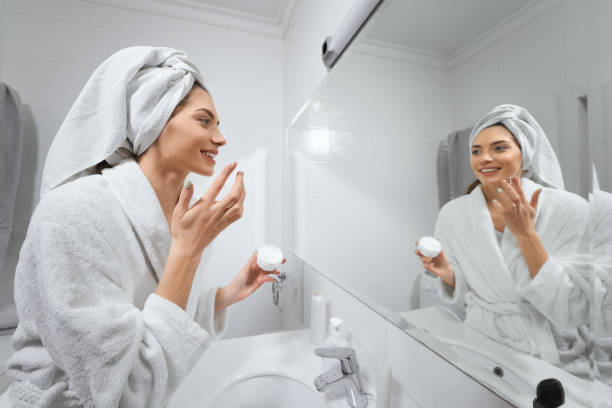 istock Beautiful woman with white towel after shower doing makeup. 1354653032