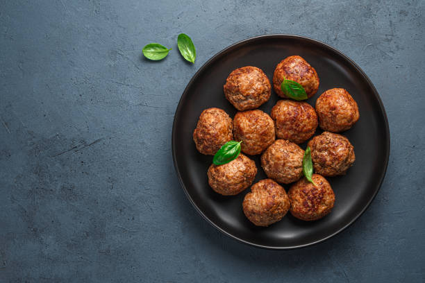 istock Fried meatballs in a black plate on a graphite background 1354654164