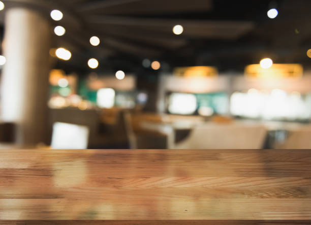 istock Empty wooden table top with lights bokeh on blur restaurant background. 1354656713