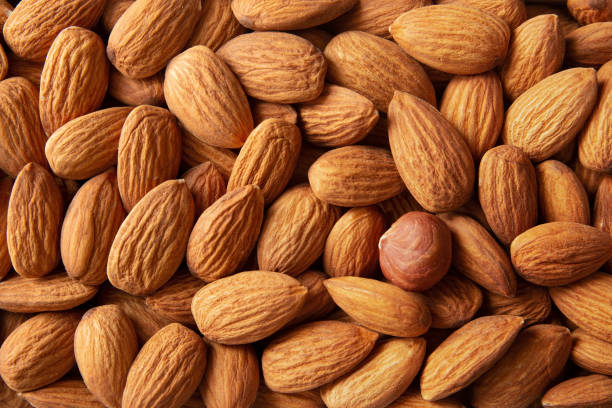 Hazelnuts among nuts of almonds. stock photo