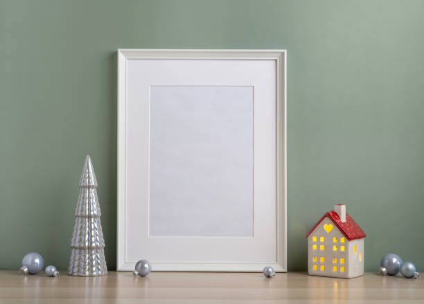 istock Christmas composition of Christmas decorations, pine branches, House lantern and a white mock up poster frame for presentation of works and text. Template. 1354662449