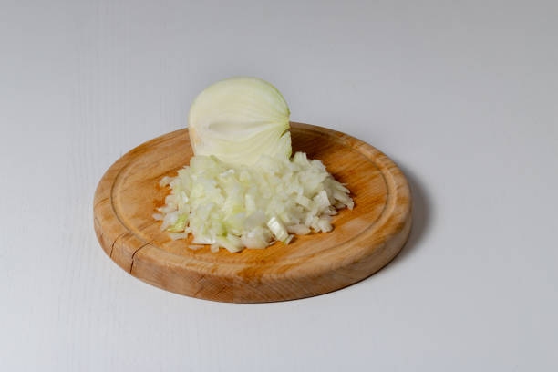 Onions finely chopped on a wooden board Onions finely chopped on a wooden board. finely stock pictures, royalty-free photos & images