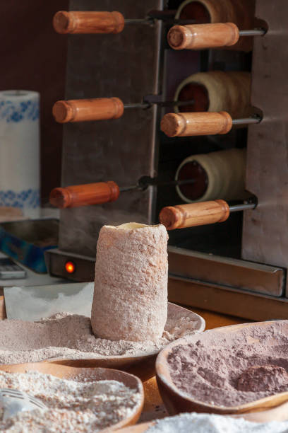 Delicacy Trdelnik freshly made on fire.