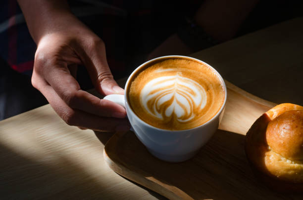 istock Coffee latte art on wooden table 1354667345
