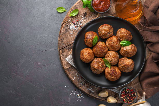 istock Fried Meatballs on a wooden board. Meat dish 1354667601