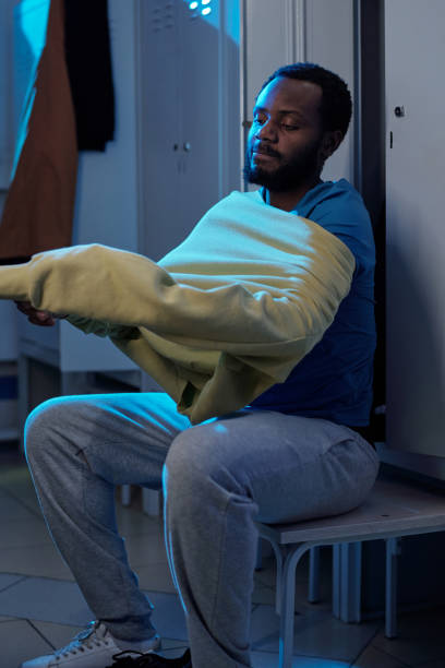 istock Bearded African sportsman putting on sweatshirt 1354672240