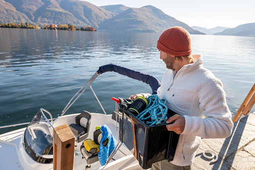 Male cleaning up boat in Autumn.
Early retirement concept