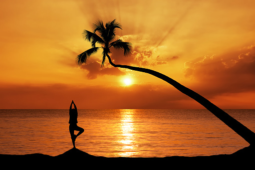 yoga girl on the beach at sunrise