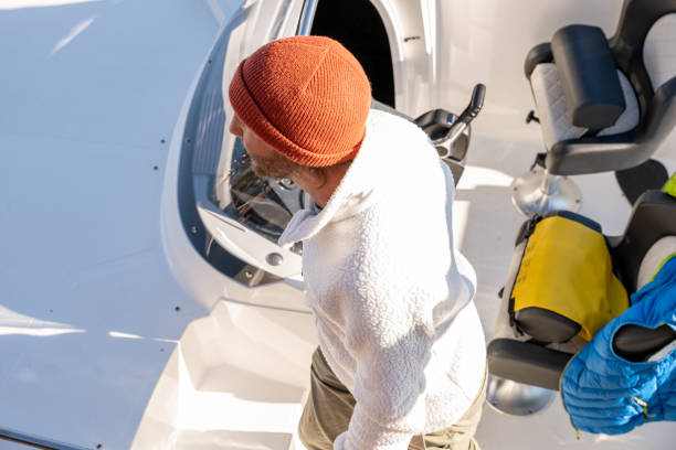 istock Young man disembarking from boat on lake in Autumn 1354674538
