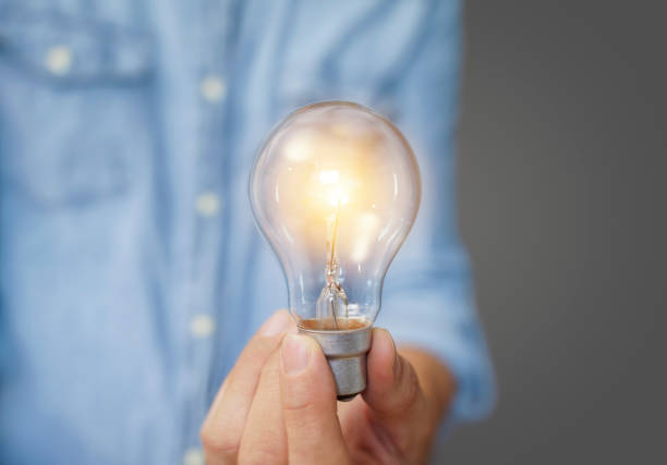 istock man holding light bulbs, ideas of new ideas with innovative technology and creativity. 1354674869