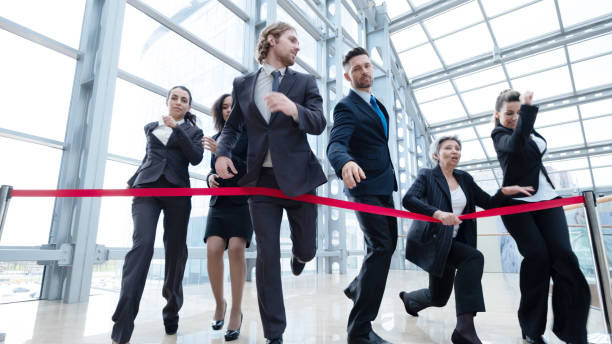 istock Businesspeople crossing the finish line 1354681148
