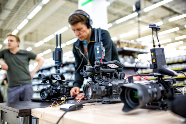 istock Videographer shooting a film or a television program in a studio with a professional camera, backstage 1354682369