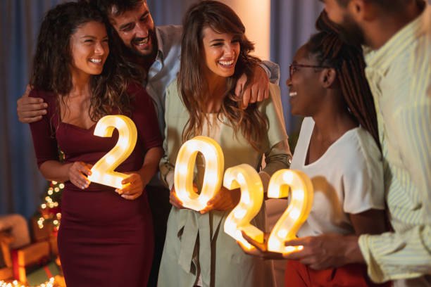 istock Friends holding numbers 2022 for New Years midnight countdown 1354683529