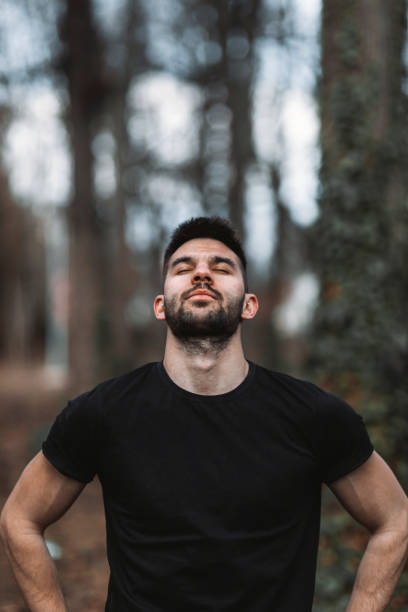 istock Relaxed man  breaths fresh air in a beautiful colorful forest 1354683679