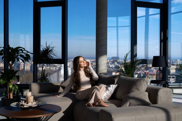 istock Adorable woman relaxing on cozy sofa 1354690858