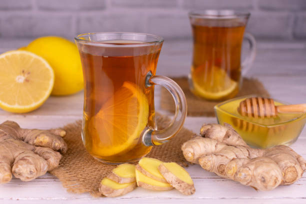 istock Two cups of ginger tea with honey and lemon. 1354693054