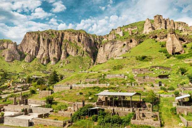 Old city cemetary and ancient cave dwellings in a town carved out of soft sandy rocks 28 May 2021, Goris, Armenia: Old city cemetary and ancient cave dwellings in a town carved out of soft sandy rocks armenia country stock pictures, royalty-free photos & images