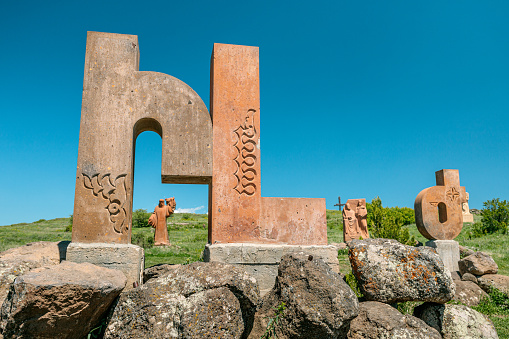 19 May 2021, Aragatsotn, Armenia: Armenian alphabet monument with stone sculptures of letters and Mesrop Mashtots