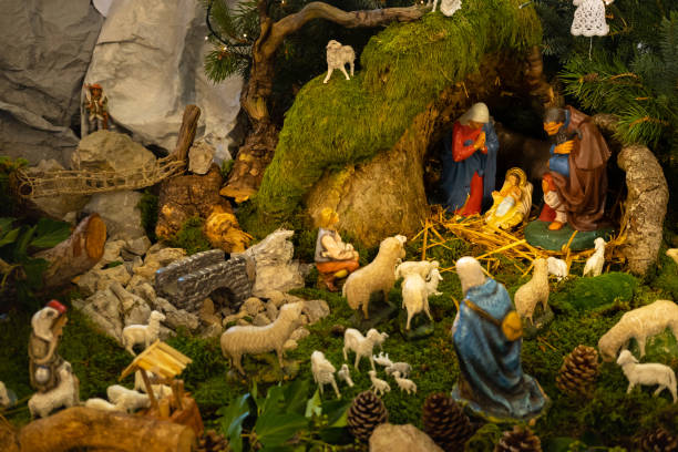 Traditional nativity scene with Joseph, Mary, baby Jesus, and animals inside a wooden manger under soft light. Concept of nativity, Christmas miracle and spiritual celebration