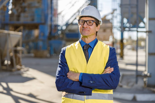 istock Joyful man engineer standing outdoors at factory 1354697133