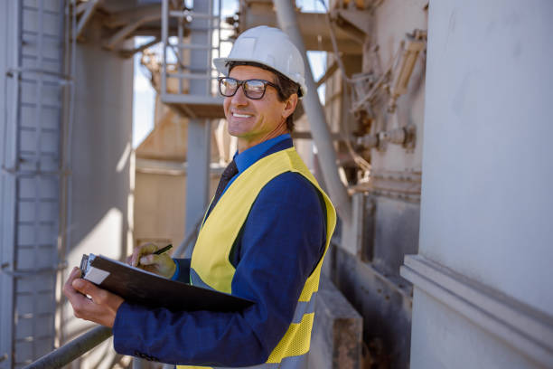 istock Joyful male engine with documents working at factory 1354697164