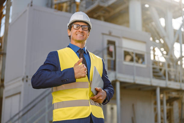 istock Cheerful factory worker holding notebook and giving thumbs up 1354697167