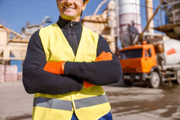 istock Cheerful man engineer standing outdoors at industrial site 1354697222