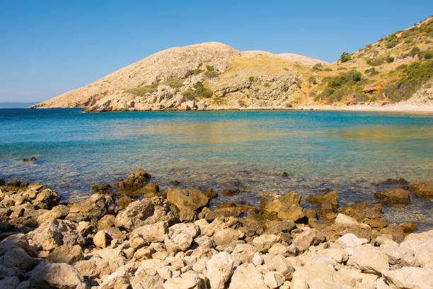 A secluded beach on the rugged coastline north of Stara Baska in the south of Krk Island, in the Primorje-Gorski Kotar County of western Croatia in late summer