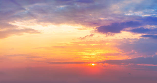 istock Dramatic  sunrise sundown sky background with gentle colorful clouds without birds. Panoramic 1354701570