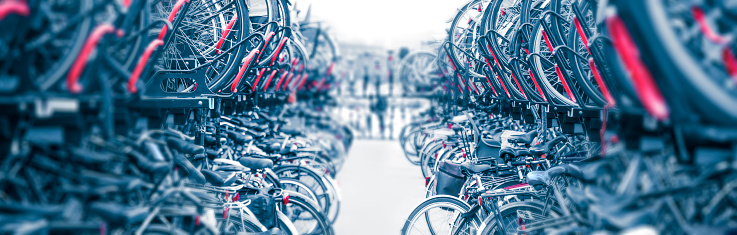 Bicycles Background - Large public city bike parking. Eco-friendly transport for a healthy life. Bicycle parking in Amsterdam, Holland, Europe. Panoramic view