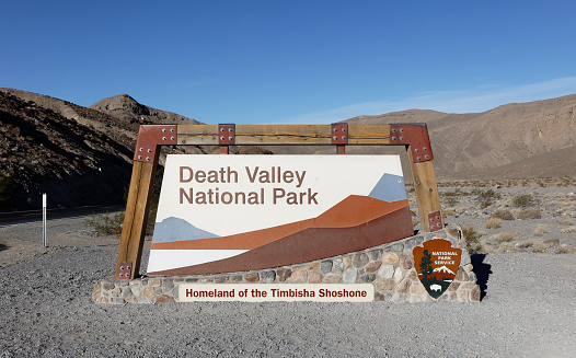 Death Valley, CA, USA - October 30, 2021: A sign at the entrance to Death Valley National Park in southeastern California. Death Valley is a desert valley in Eastern California, in the northern Mojave Desert.