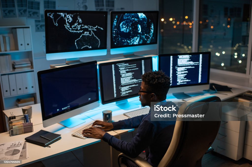 Software Developer Working On Computer Young Contemporary Software Developer Working By Computer Stock Photo ...