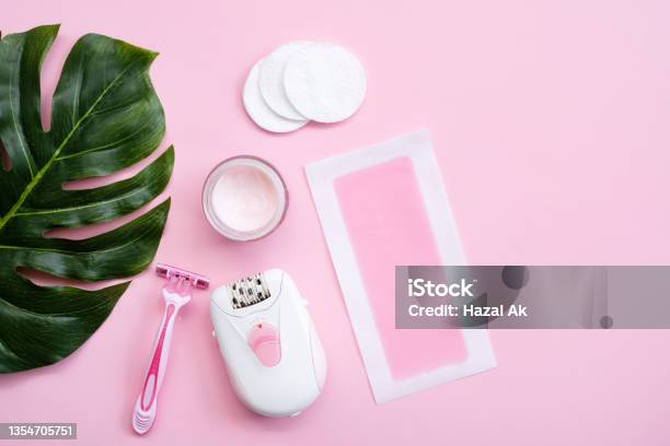 Pink Epilator With Wax Strips And Razor For Removal Of Unwanted Hair Flat Lay Stock Photo - Download Image Now