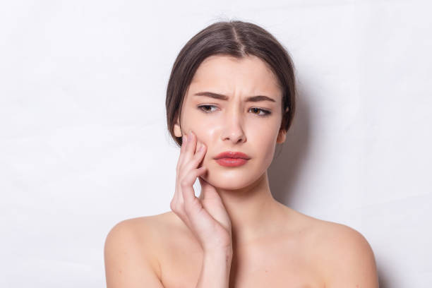 istock beautiful young woman has toothache 1354707692