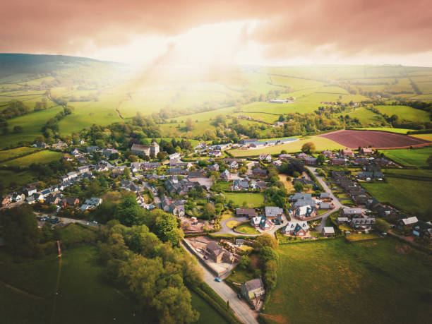 istock Sun bursting through clouds over traditional UK British houses 1354710643