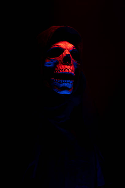 istock Skull in red light on black background with free space for text. 1354710698