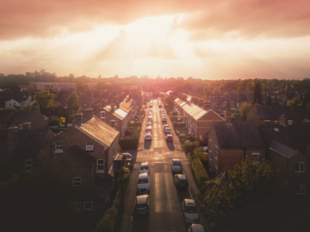 istock Sun bursting through clouds over traditional UK British houses 1354710731