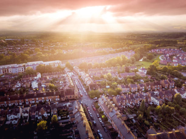istock Sun bursting through clouds over traditional UK British houses 1354710773