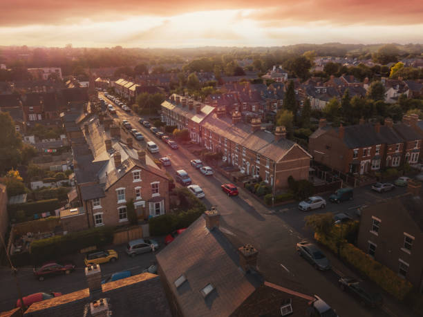 istock Sun bursting through clouds over traditional UK British houses 1354710788